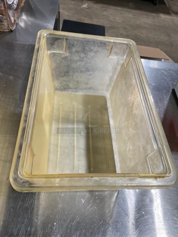 Cambro commercial clear food storage container with lid. Used condition, ideal for foodservice. Clear material shows wear.