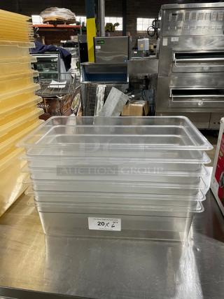 Cambro clear polycarbonate food pans stacked on a stainless steel counter. Tag indicates 20 units.