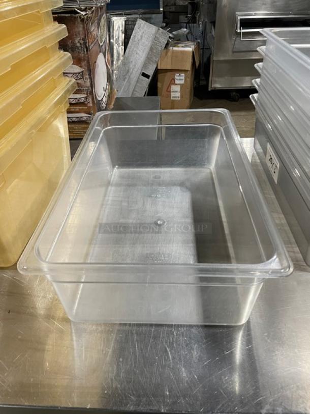 Clear Cambro polycarbonate food pan, commercial-grade, transparent, rectangular, on a metal surface, excellent condition.