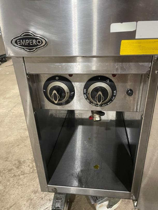 Empero commercial stainless steel deep fat fryer with control dials and drip tray. Includes basket hanger, fry baskets, and casters.