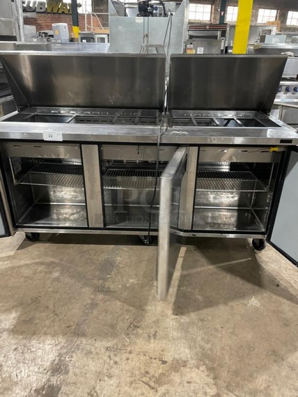Turbo-Air MST-72-30-N stainless steel 3-door refrigerated prep table, with poly-coated wire rack, 115V, on casters.