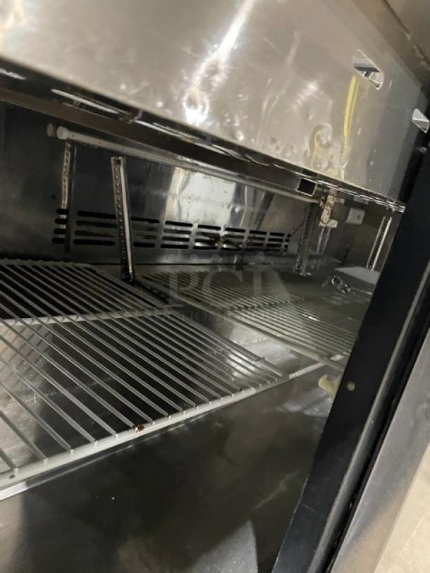 Turbo-Air MST-72-30-N refrigerated prep table interior with poly coated wire rack, stainless steel, good condition.