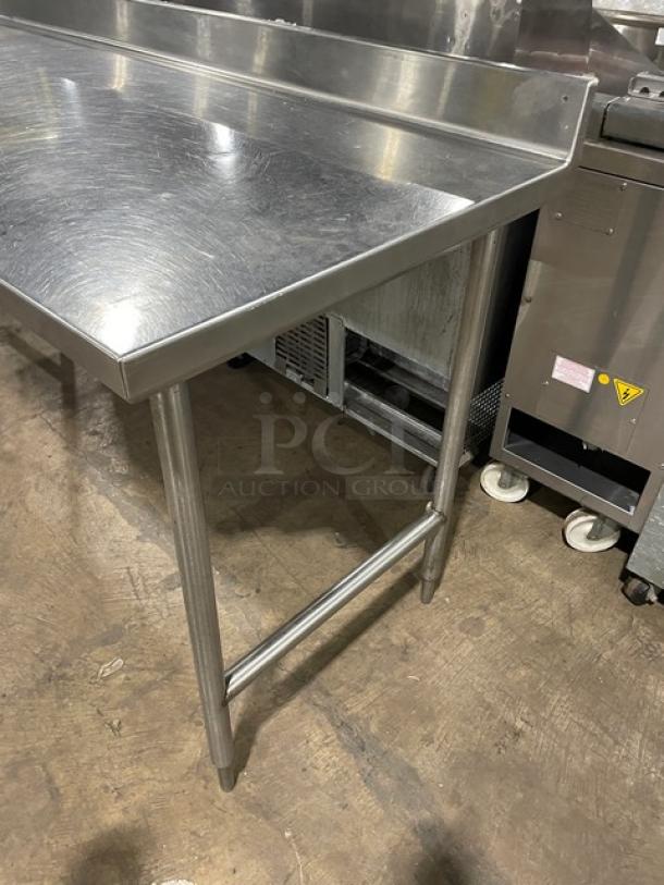 Commercial stainless steel worktop/prep table with single compartment sink, backsplash, and swing spout faucet on sturdy legs.