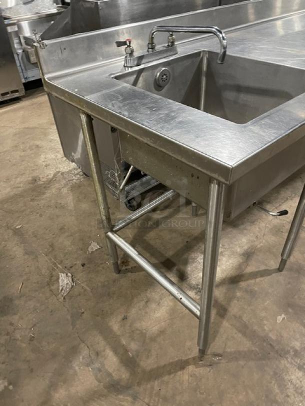 Commercial stainless steel worktop/prep table with single compartment sink, backsplash, swing spout faucet, and sturdy legs.