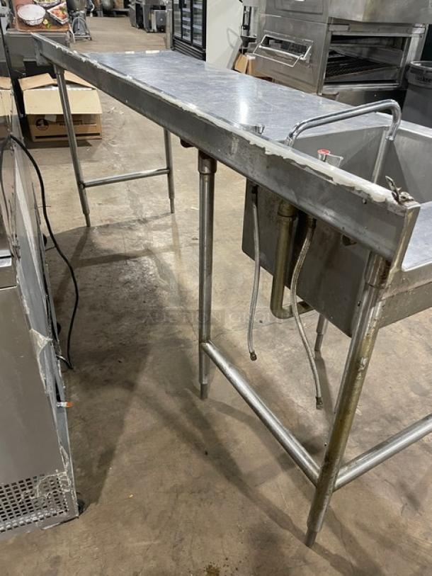 Commercial stainless steel worktop/prep table with single compartment sink, backsplash, and swing spout faucet on legs.
