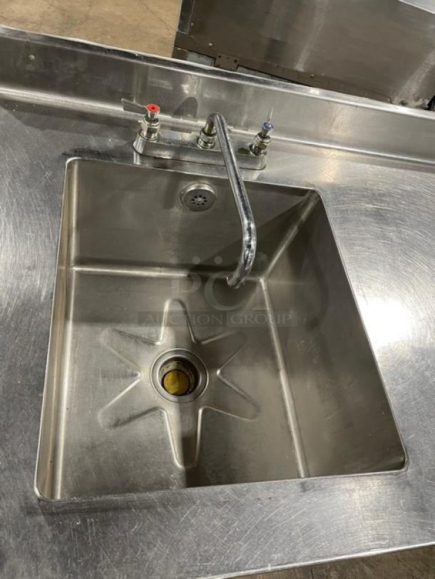 Commercial stainless steel worktop prep table with a single compartment sink, backsplash, swing spout faucet, and mounted on legs.