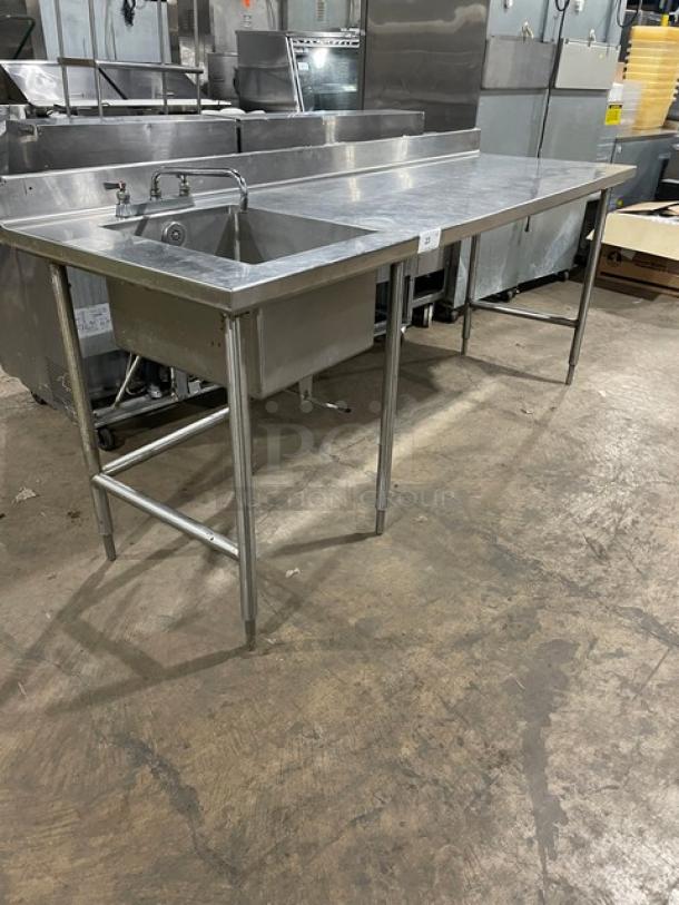 Commercial stainless steel worktop/prep table with single compartment sink, backsplash, swing spout faucet, and legs.