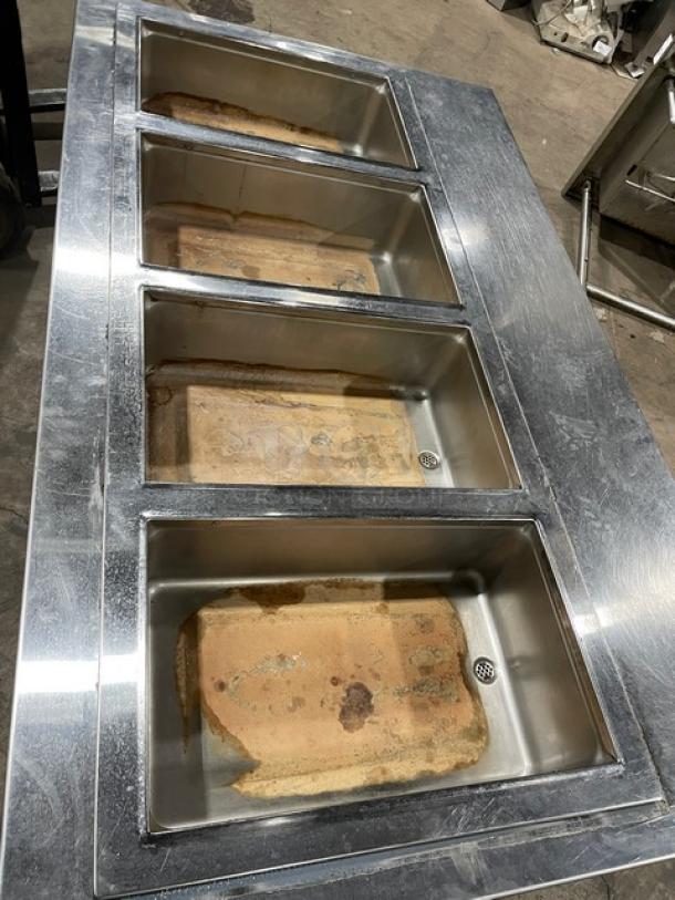 Wells MOD400TDM stainless steel 4-well hot food steamtable, electric-powered, used condition, 208/240V, on legs.