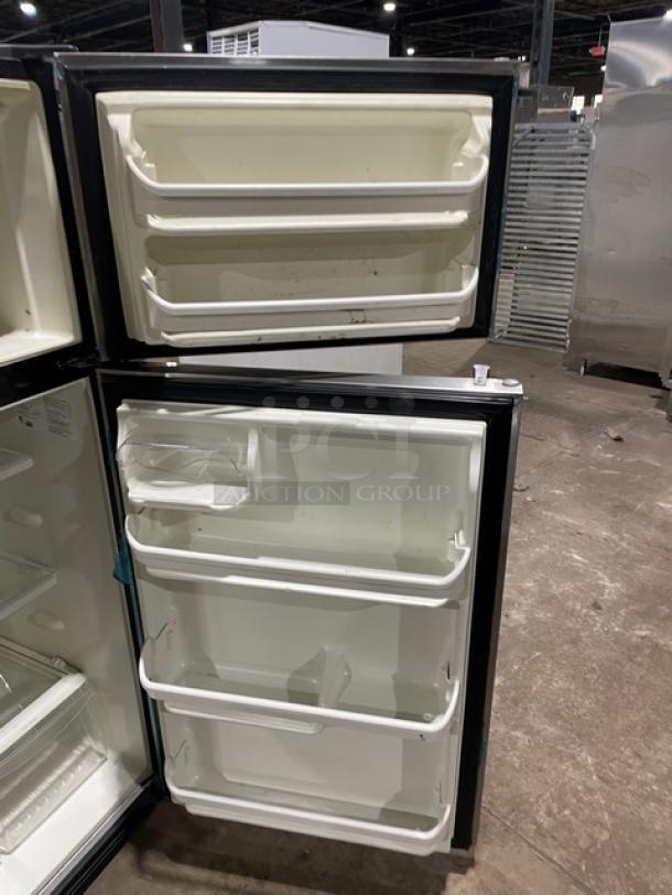 Frigidaire stainless steel dual-section fridge/freezer, model FFTR1821QS3, with clear drawers and adjustable shelves.