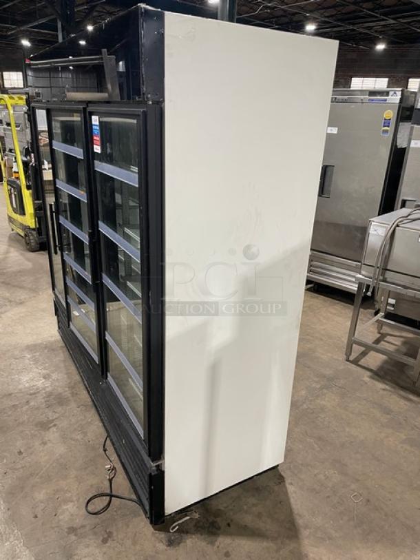 True GDM-72 commercial merchandiser refrigerator, triple glass swing doors, poly coated wire racks, 115V, used condition.
