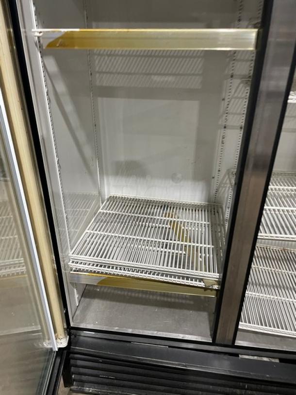 True GDM-72 commercial triple glass door merchandiser refrigerator with poly-coated wire racks, 115V, 1 phase, serial number 1-2834463.