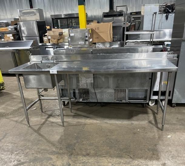 Commercial stainless steel worktop/prep table with single compartment sink, backsplash, and swing spout faucet on sturdy legs.