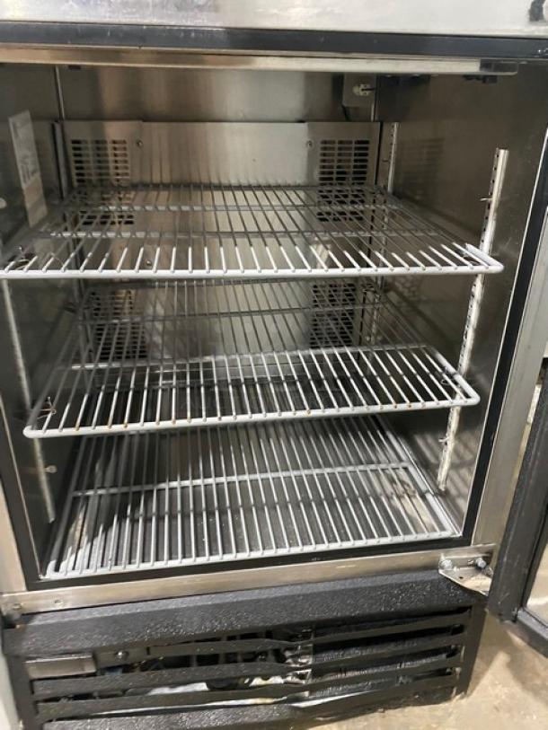 Glastender MFV24GNL mug chiller, 2018 model, stainless steel with black powder coating, poly-coated wire racks, open door view.