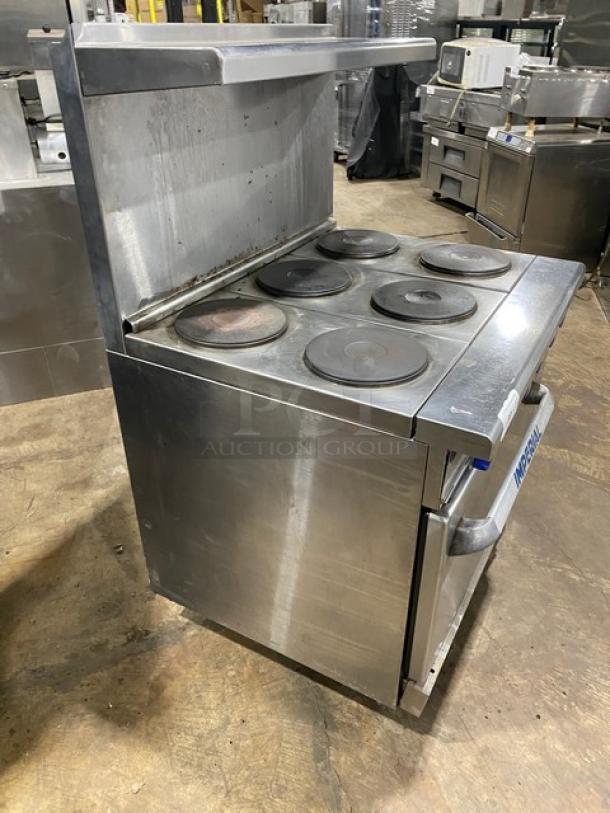 Imperial stainless steel electric 6-burner hot plate range/oven combo with backsplash, overhead salamander shelf, and wired oven rack.