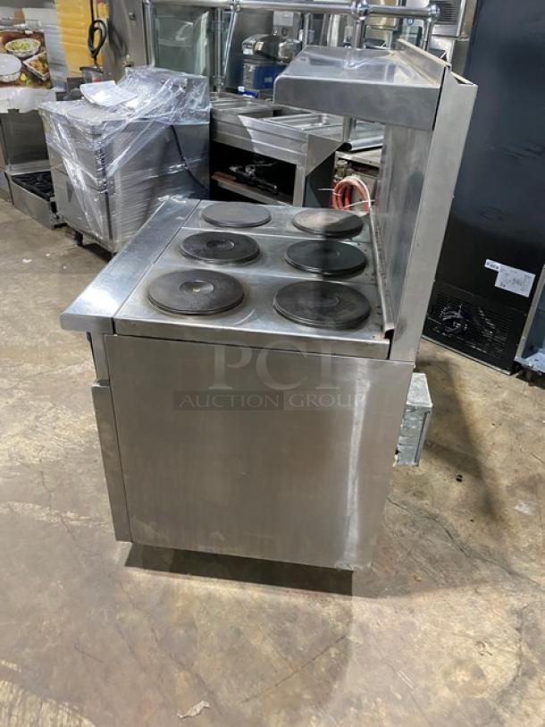 Imperial Commercial Stainless Steel 6-burner electric range/oven combo with backsplash, overhead salamander shelf, and wired oven rack.