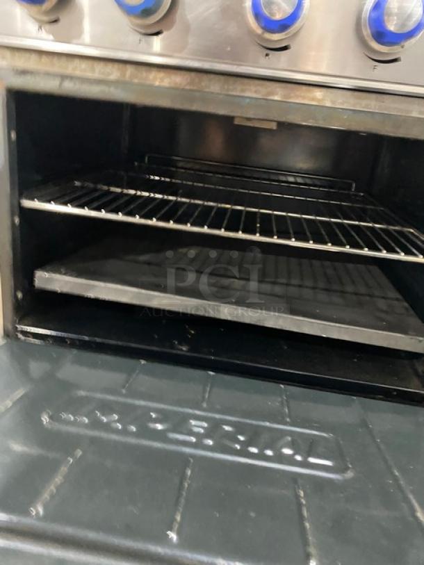 Imperial Commercial Stainless Steel 6 Burner Hot Plate Range/Oven Combo with back splash, overhead salamander shelf, wired rack.
