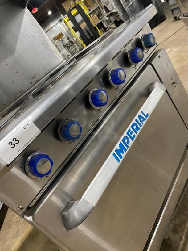 Imperial commercial stainless steel electric 6-burner hot plate range/oven combo with back splash, salamander shelf, and wired oven rack.