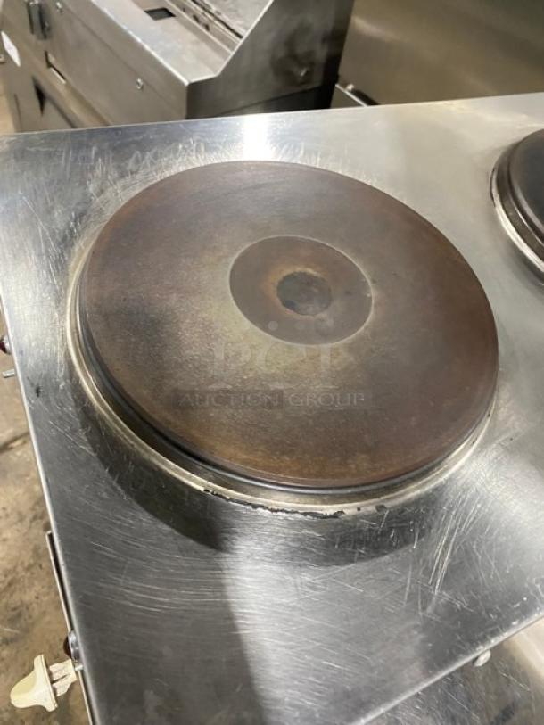 Commercial stainless steel electric countertop dual burner hot plate on legs. Shows signs of use, good condition.