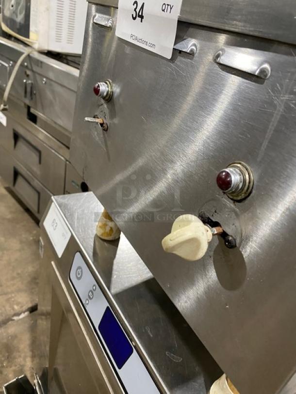 Stainless steel electric dual burner hot plate with control knobs, on legs, in good condition. Auction label "34 QTY" affixed.