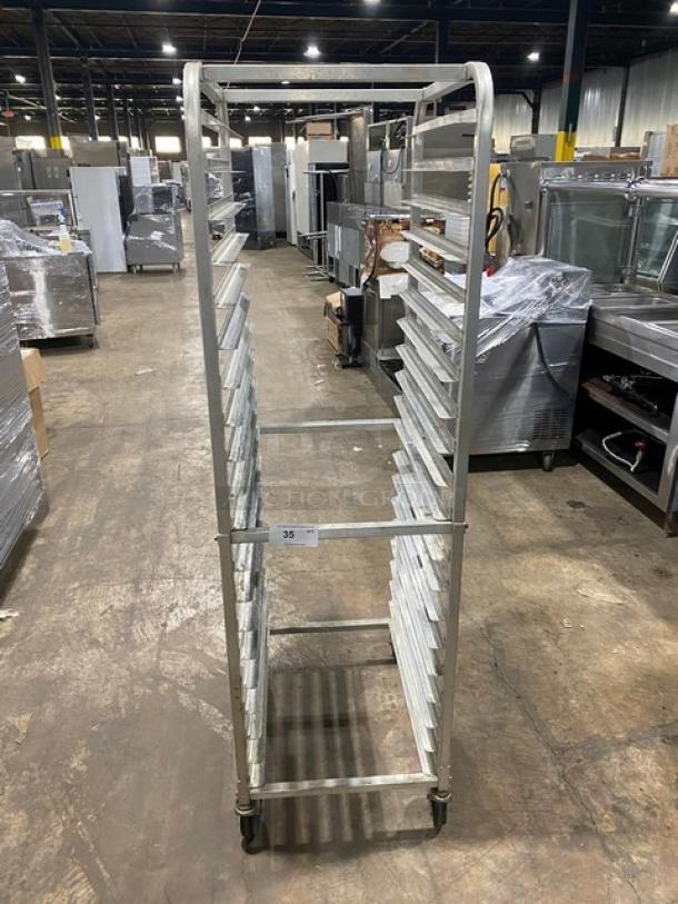 Winco ALRK-20 aluminum 20-pan end-load sheet pan rack on casters, shown in a commercial setting.