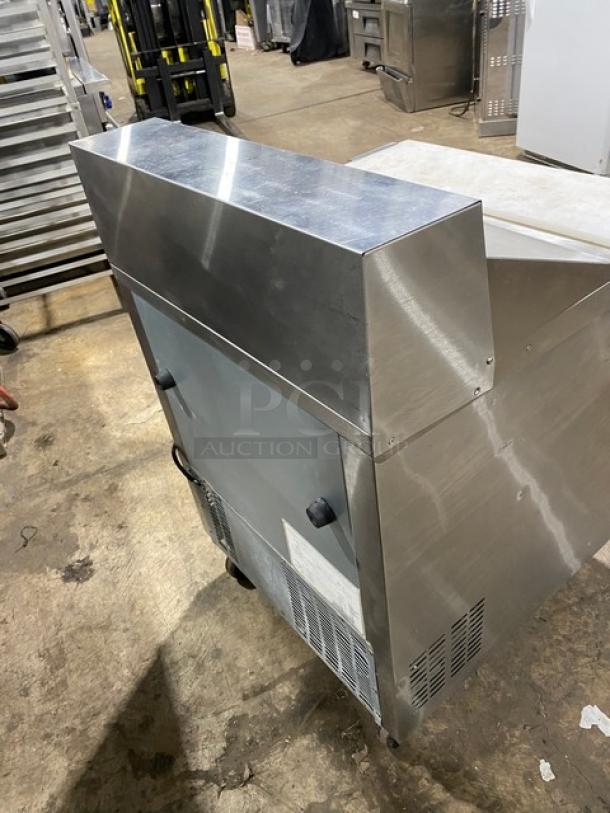 Everest stainless steel refrigerated prep table with two drawers, cutting board, and casters. Commercial-grade, excellent condition.