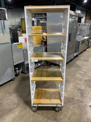 Commercial white 4-tier utility cart with built-in pan slides and wooden-style shelves, on casters, in good condition.