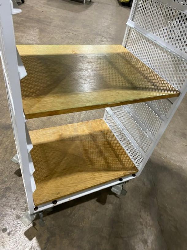 Commercial white 4-tier utility cart with built-in pan slides, wooden-style shelves, and casters. Appears in good condition.