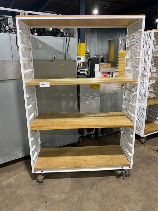 Commercial white 3-tier utility cart with built-in pan slides, wooden-style shelves, and caster wheels.