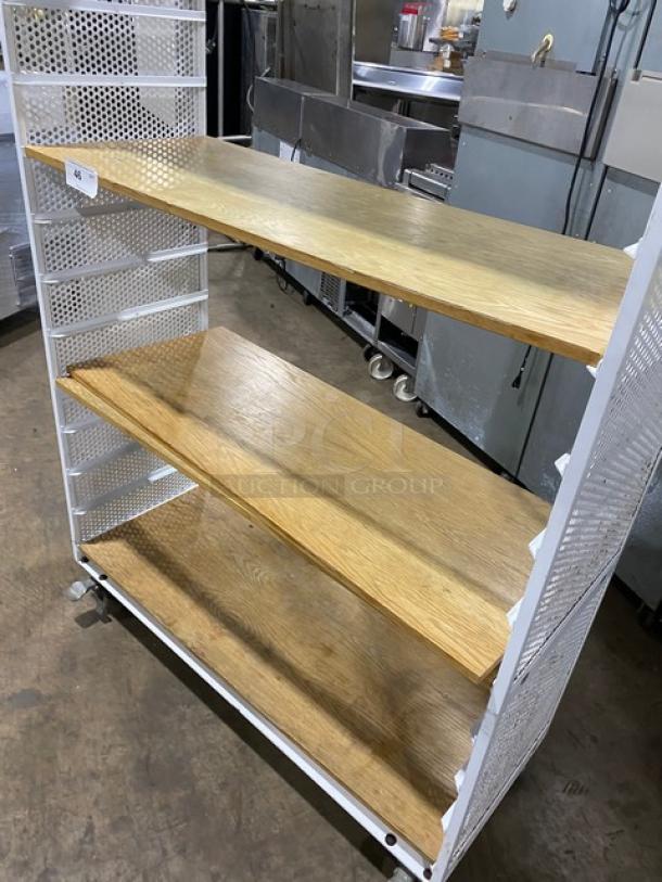 Commercial white 3-tier utility cart with built-in pan slides, wooden-style shelves, and casters. Ideal for holding pans.