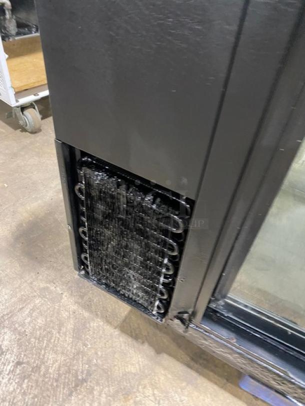 True commercial black double glass sliding door back bar cooler, model TBB-24-60G-SD, with stainless steel worktop.