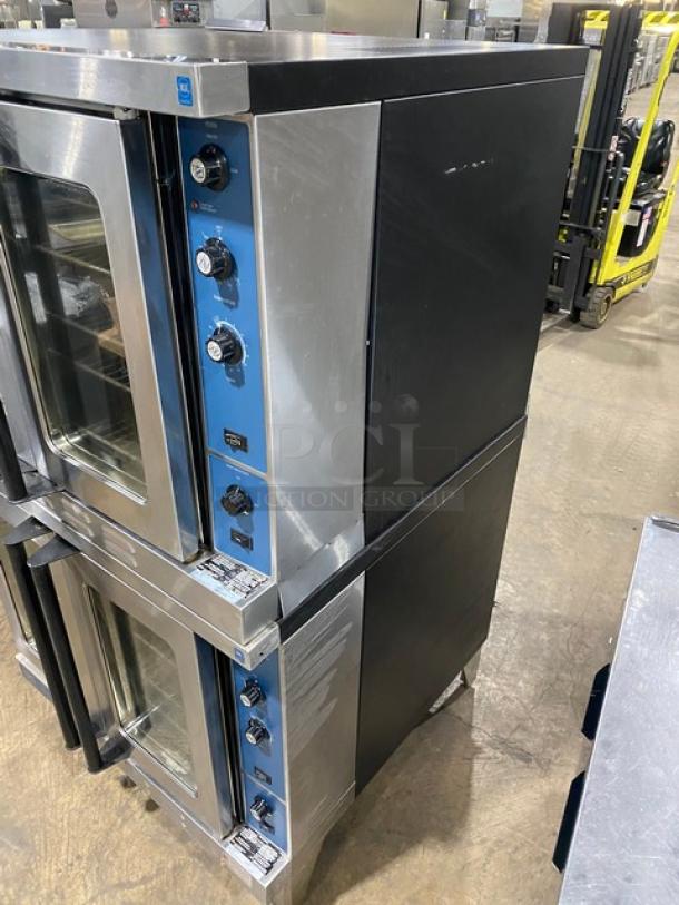 Duke E101GV stainless steel double stacked convection oven, natural gas, with thermostatic controls, wired racks, on legs.