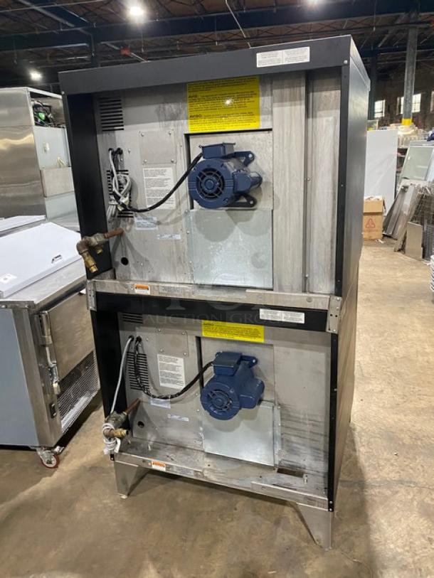 Duke Model E101GV double-stacked convection oven, stainless steel, natural gas, thermostatic controls, on legs, industrial setting.