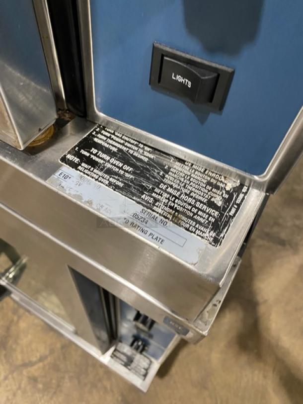 Duke commercial stainless steel double-stacked convection oven, model E101GV, with thermostatic controls and wired racks.