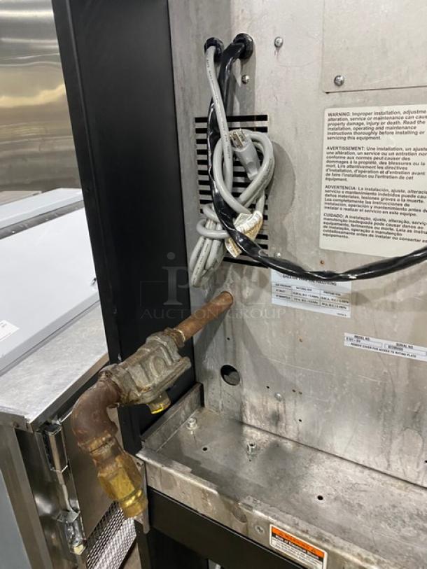 Duke E101GV commercial natural gas double stacked stainless steel convection oven; visible cords and labels; on legs.