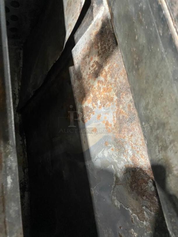 Bakers Pride stainless steel pizza deck oven interior showing signs of rust and wear, thermostatic control not visible.