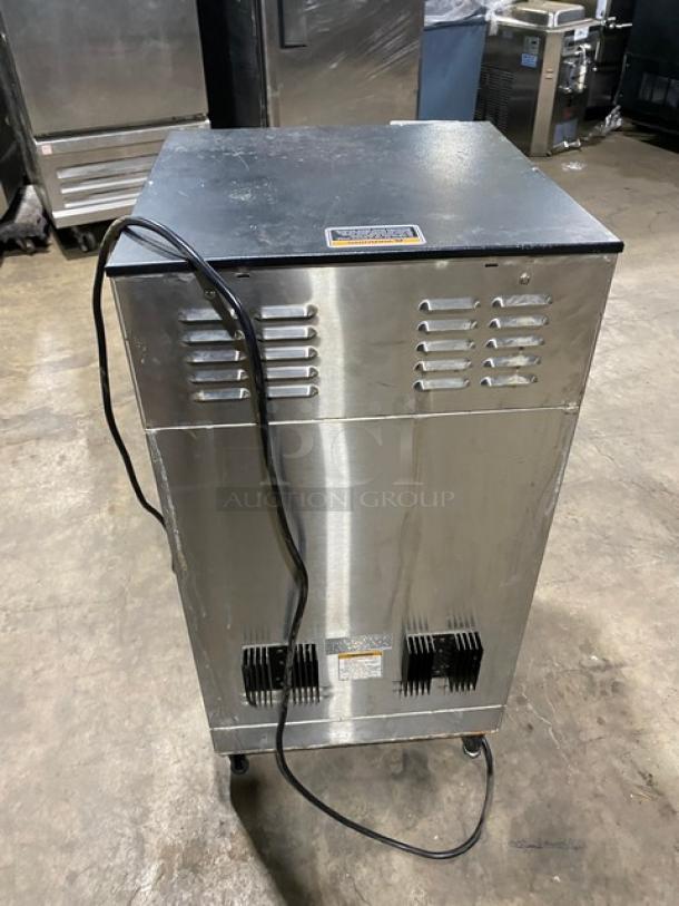Bunn Dual DBC Series stainless steel twin coffee brewer, model DUALSHDBC, electric, on legs, with attached power cord.