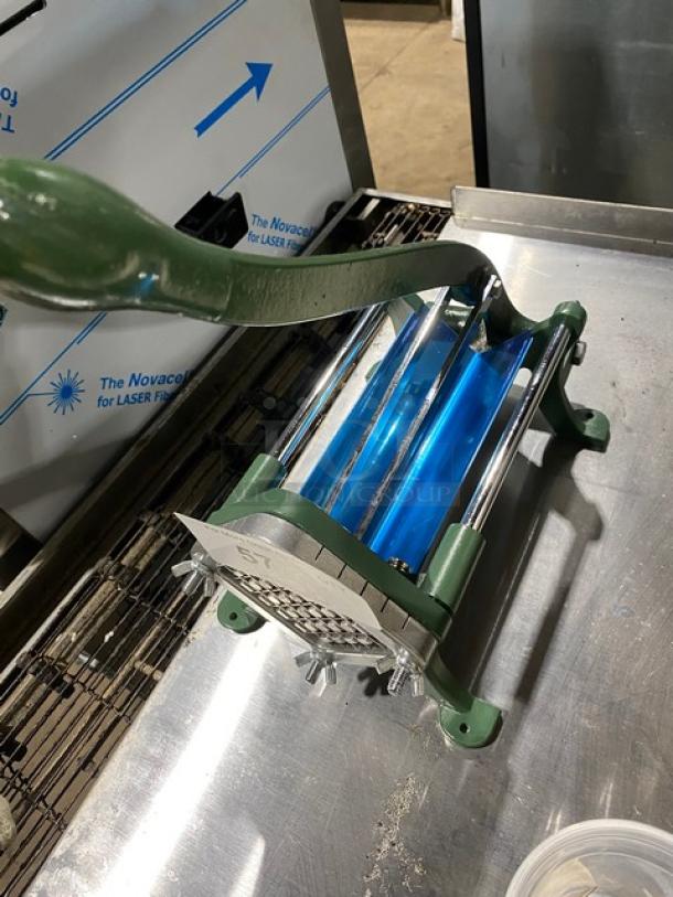 Commercial green heavy-duty manual French fry cutter with a lever, stainless steel blades, mounted on sturdy legs.
