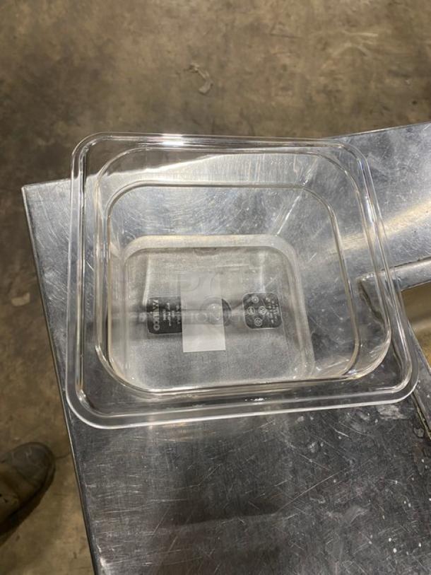 Winco SP7604 clear polycarbonate 1/6-size 4" deep food pan, new condition, on stainless steel surface.
