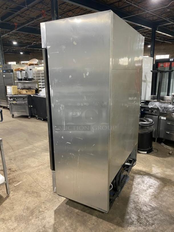 True T49F stainless steel 2-door reach-in freezer, side view, shows wear. Features poly-coated wire rack. Model: T-49F SN: 1-3198372.