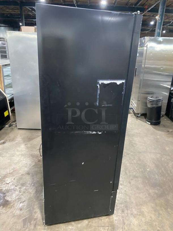 Kool-It black merchandiser freezer, Model 163-LX-46FB, poly-coated shelves, casters, used condition.