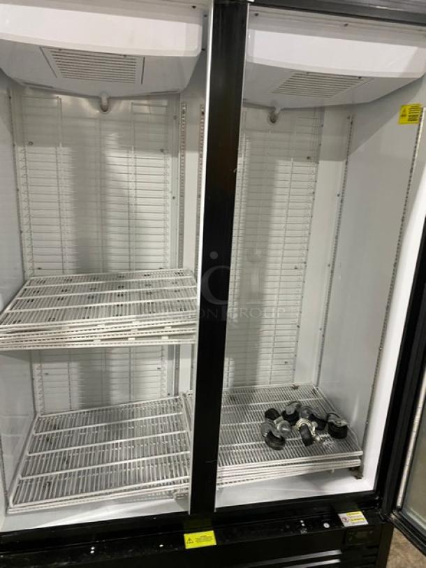 Kool-It Signature Series black double glass door merchandiser freezer, model 163LX46FB, with wire racks and casters.