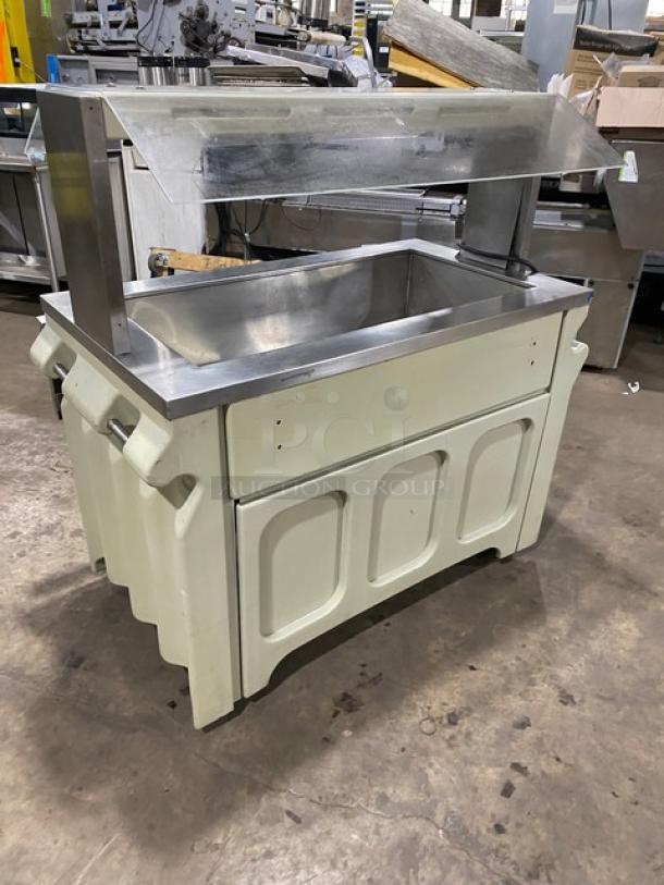Custom buffet-style commercial stainless steel portable cold food/salad bar with sneeze guard, folding tray slide, on casters.