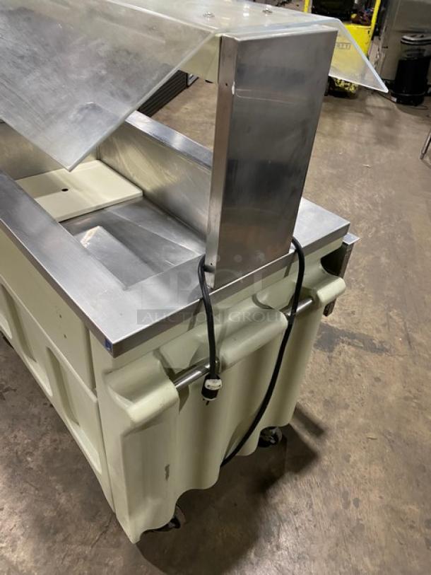 Custom buffet-style stainless steel cold food salad bar with sneeze guard, folding tray slide, and casters.