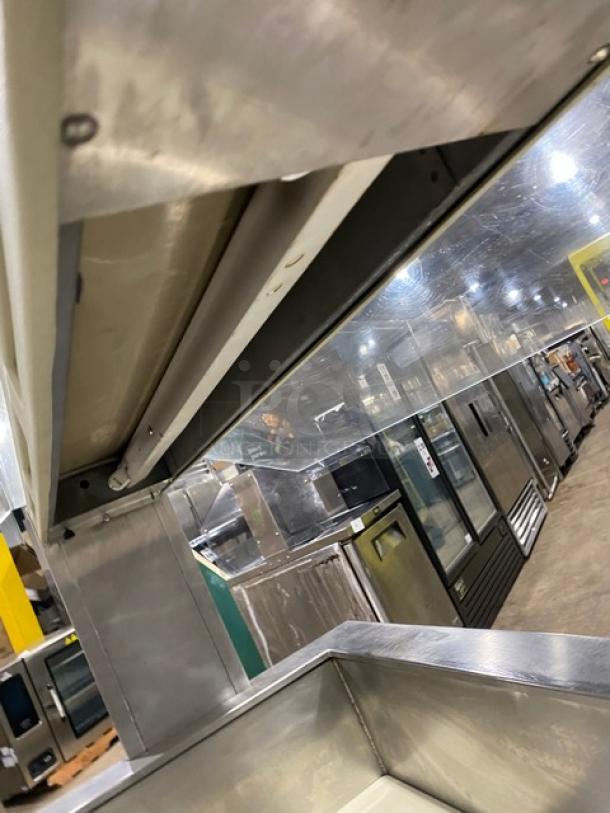 Commercial stainless steel cold food/salad bar with sneeze guard, folding tray slide, and casters, in excellent condition.