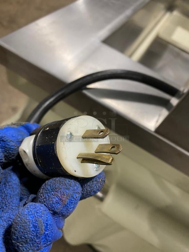 Close-up of a power plug for a custom stainless steel cold food salad bar.