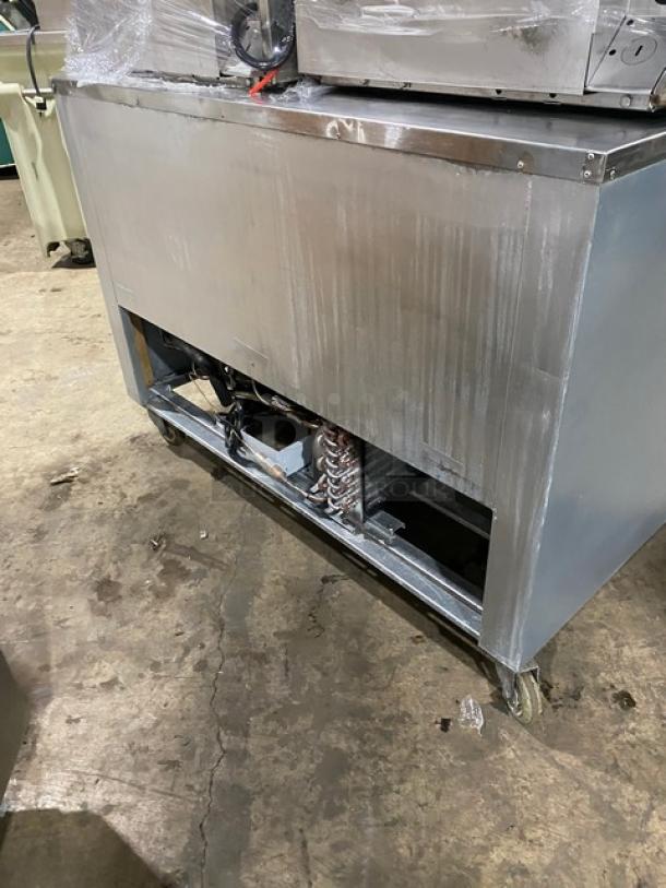 CoolTech CMPH-48LBB commercial stainless steel 2-door lowboy refrigerator on casters. Visible compressor and wiring.
