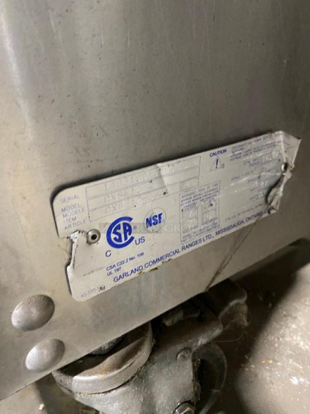 Garland CXBE12 dual-side clam shell broiler, stainless steel, electric, on casters, visible model label.