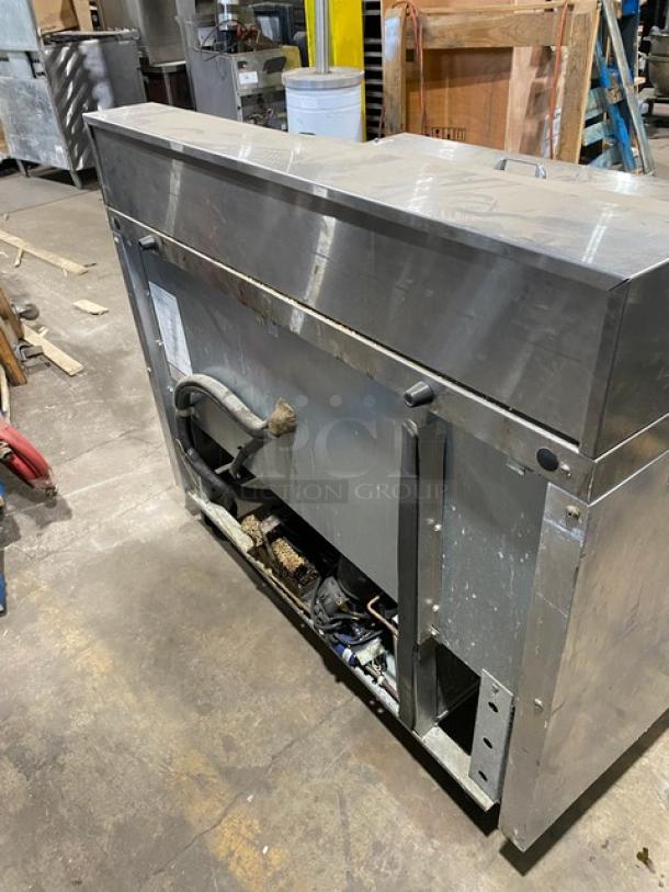 Continental 2-door stainless steel refrigerated Bain Marie prep table, poly coated wire racks, on casters, commercial use.