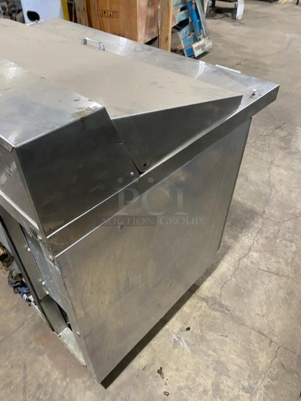 Continental stainless steel 2-door refrigerated prep table with poly-coated wire racks, on casters, shown in industrial setting.