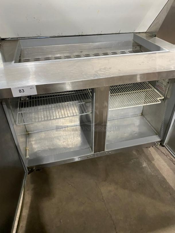Continental stainless steel 2-door refrigerated prep table, bain marie style, with poly-coated wire racks, on casters.